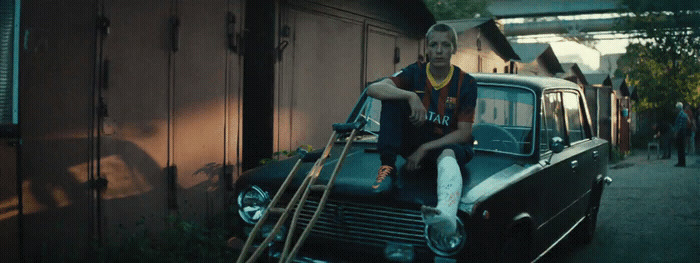 a man sitting on top of an old car