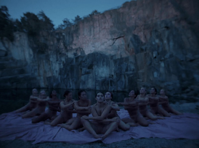 a group of women sitting on top of a blanket