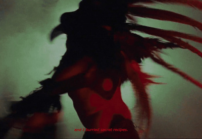 a woman in a red dress with feathers on her head