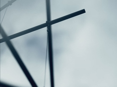 a close up of a cross on a cloudy day