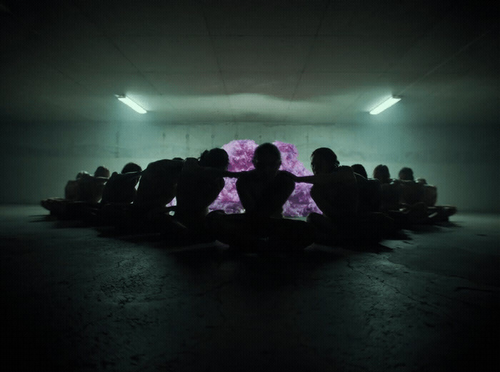 a group of people sitting in a dark room