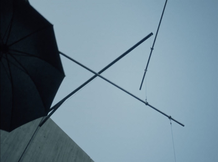 a black umbrella sitting next to a tall building