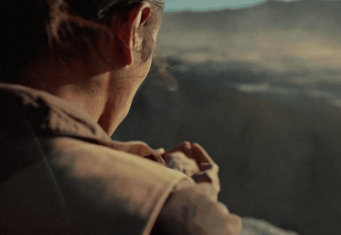 a man standing in front of a mountain