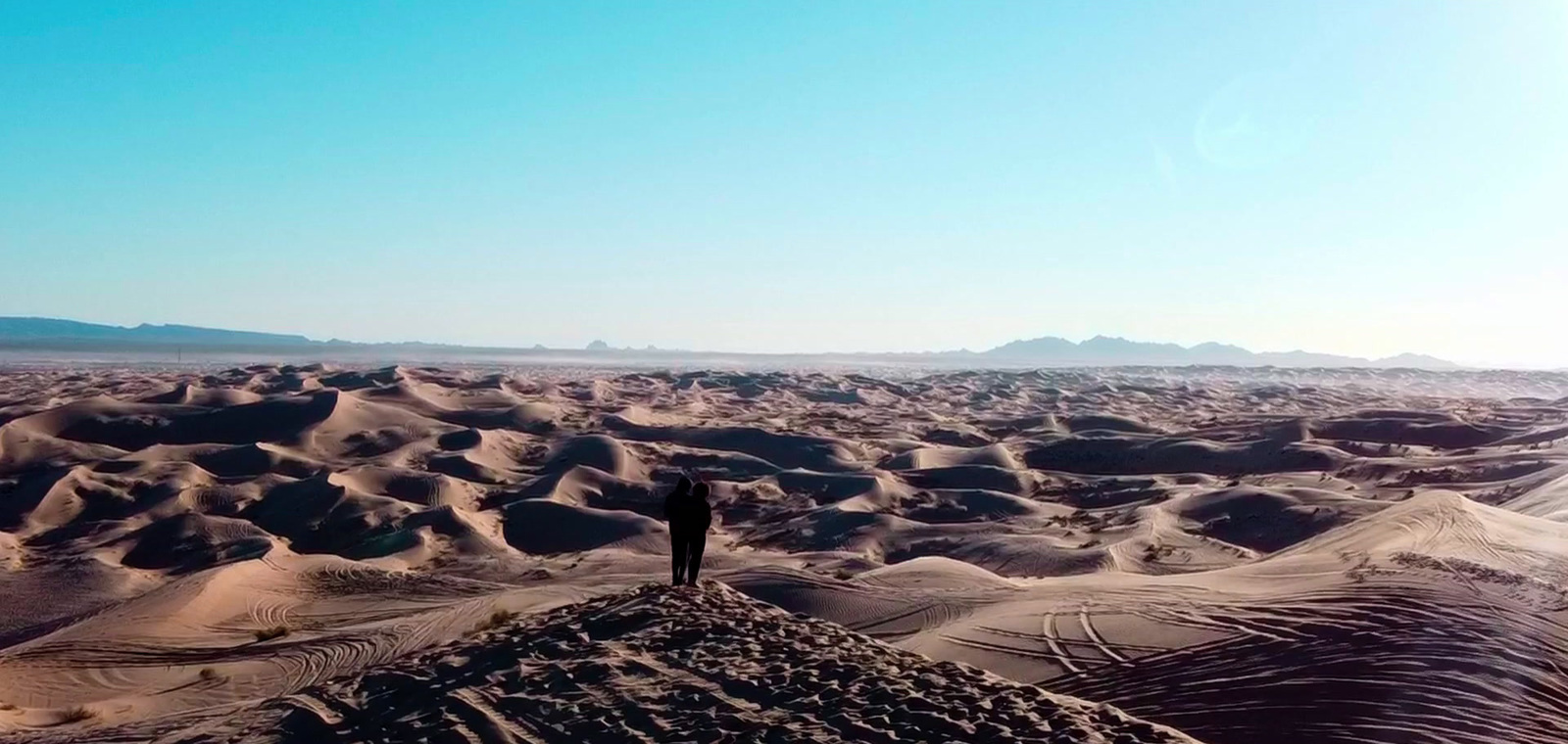 a person standing in the middle of a desert