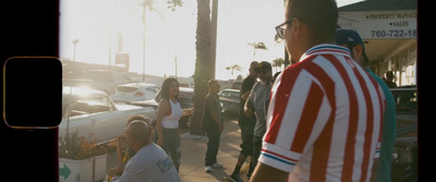 a group of people standing on the side of a road