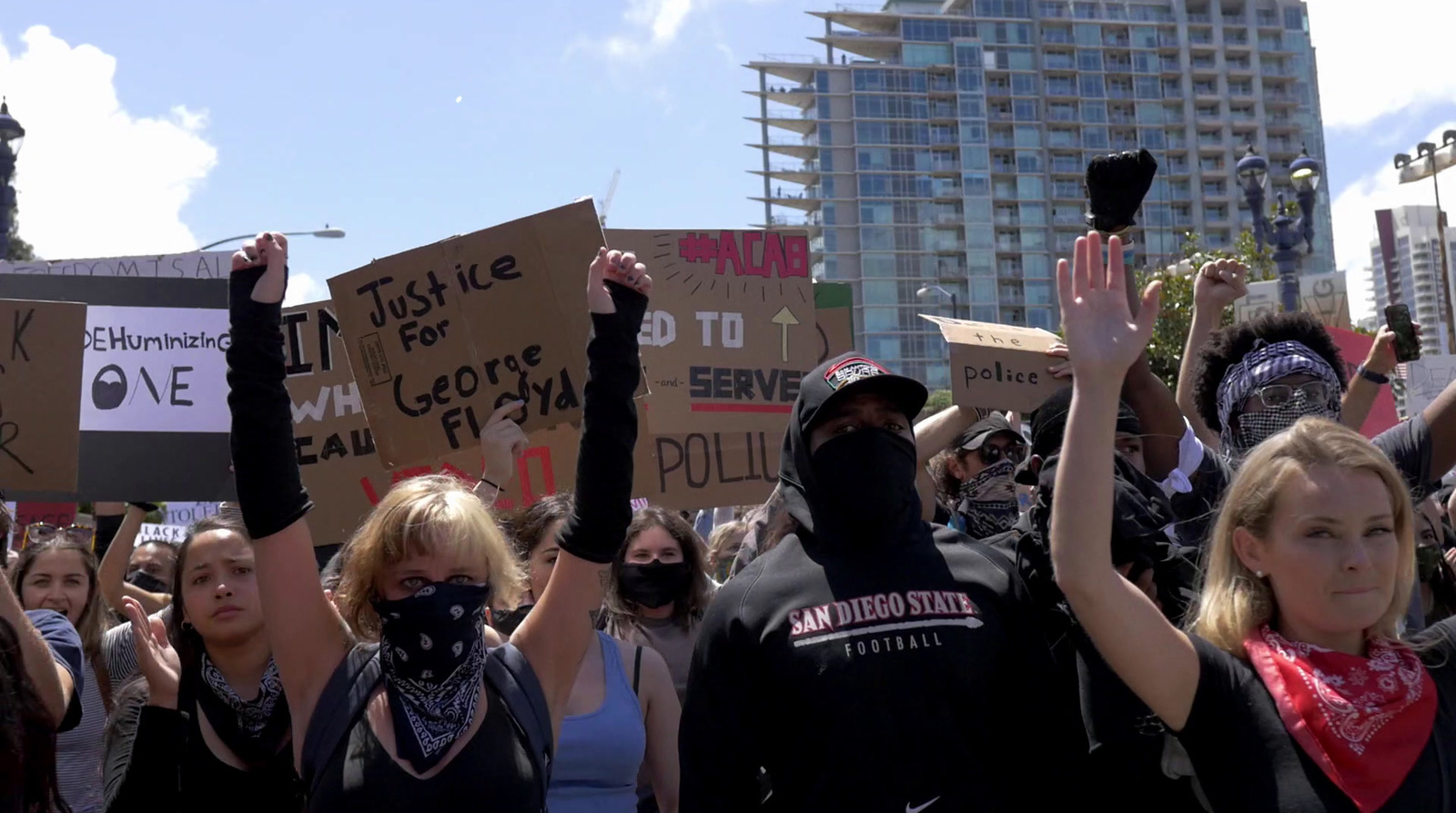 a group of people holding up signs in the air