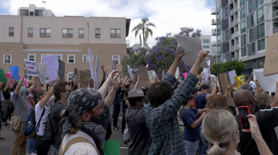 a group of people holding up signs in the air