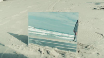 a picture of a person walking on a beach