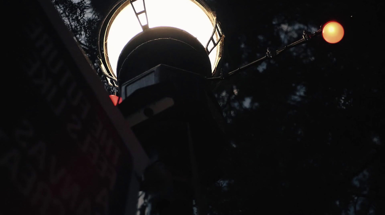 a street light with a street sign below it