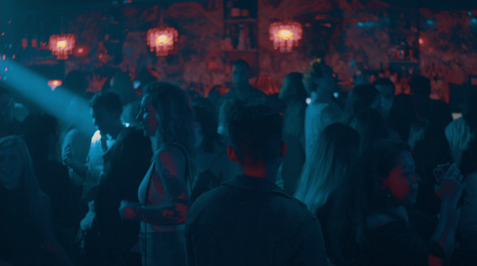 a group of people standing in a dark room