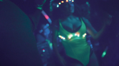 a woman in a neon green bodysuit is dancing