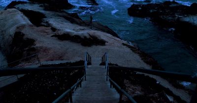 a set of stairs leading down to the ocean