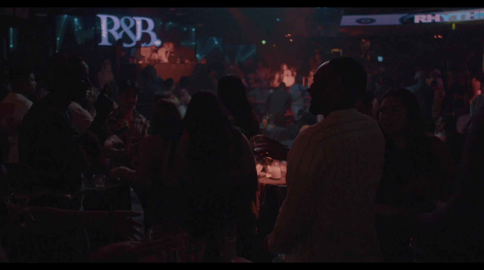 a group of people standing around a bar