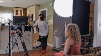 a man and a woman in a room with a camera