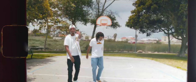 a couple of men standing on top of a basketball court