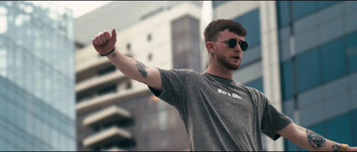 a man with a tattoo on his arm holding a frisbee