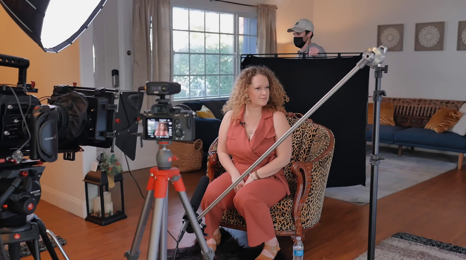 a woman sitting in a chair in front of a camera