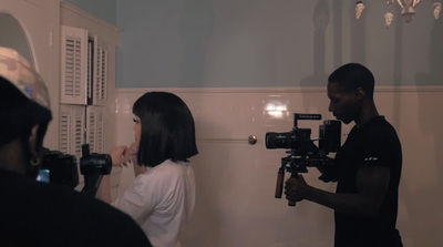 a man and a woman are filming in a bathroom