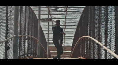 a man in a black wet suit is walking up a set of stairs