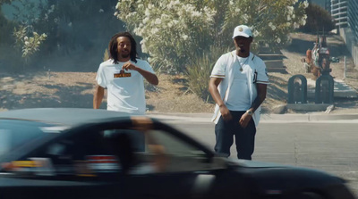 a couple of men standing next to each other on a street