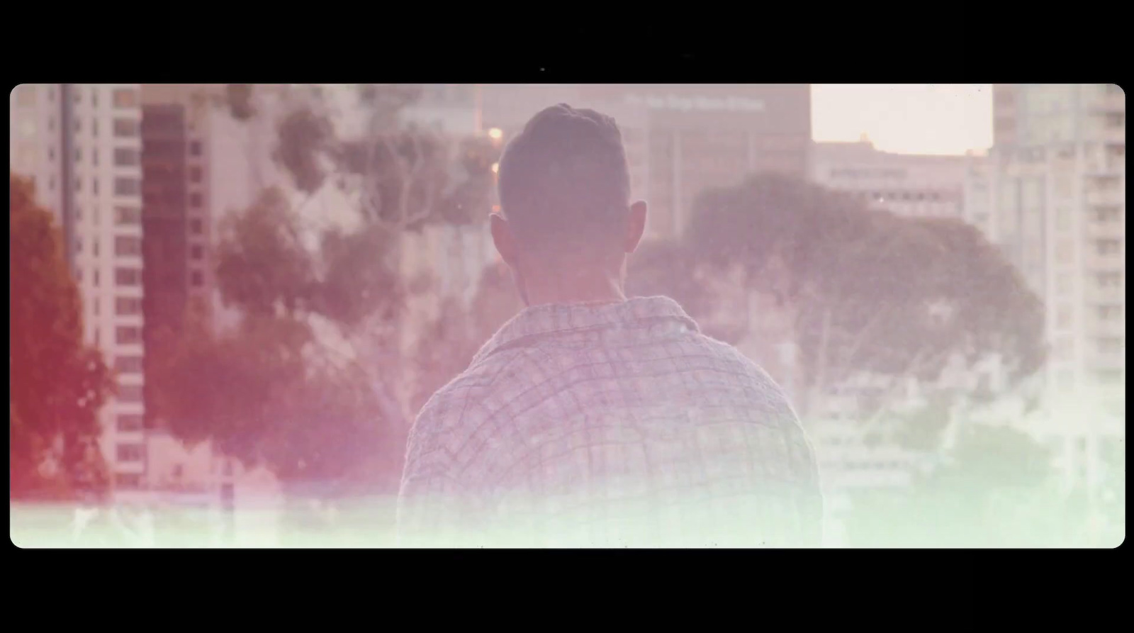 a man standing in front of a city skyline