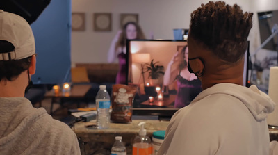 a couple of people that are sitting in front of a tv