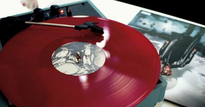 a red record player sitting on top of a table