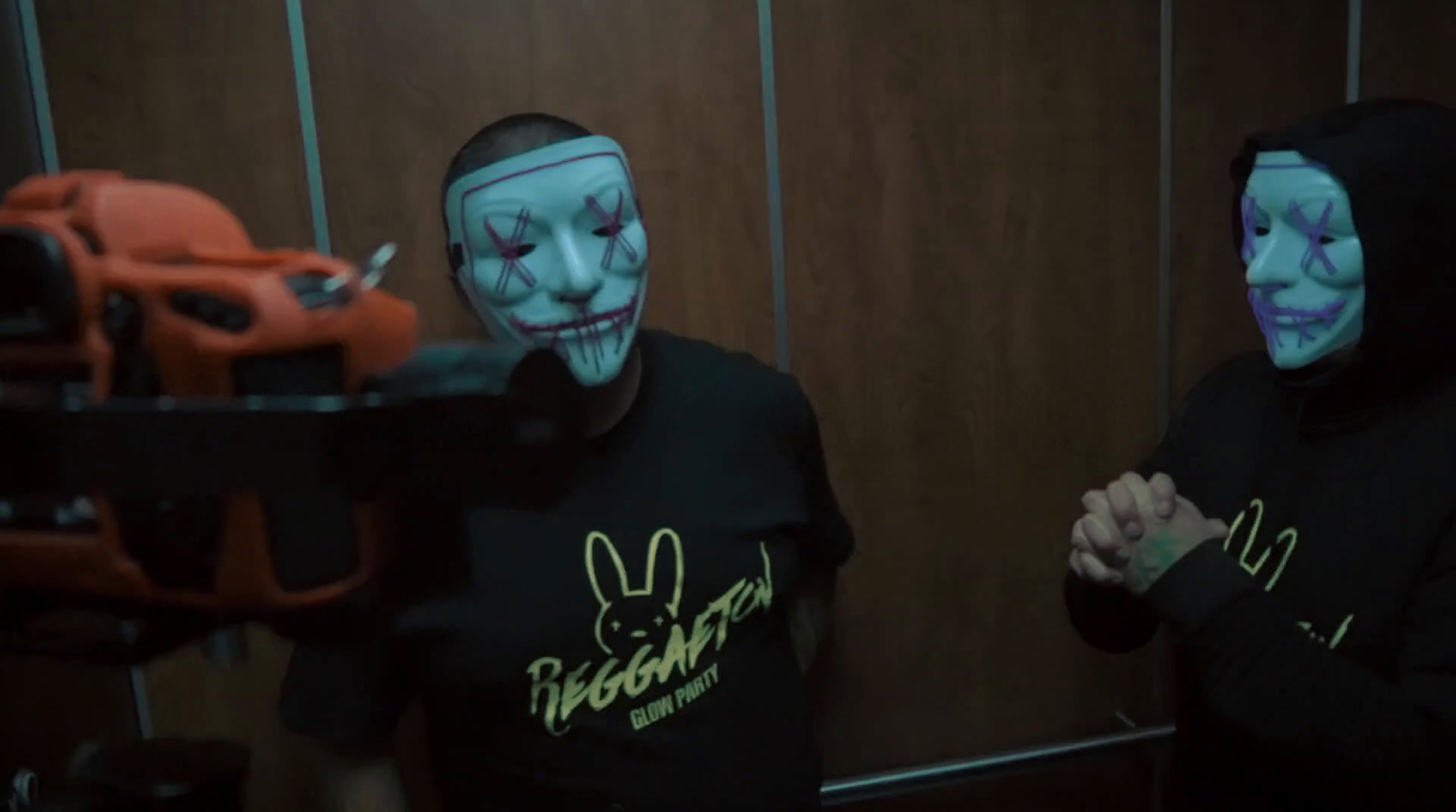 two people wearing face paint and holding a gun