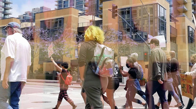 a group of people walking across a street