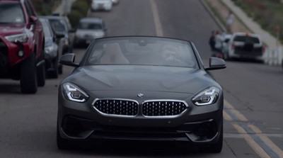 a car driving down a street next to other cars