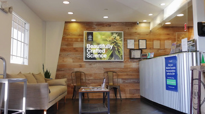 a reception area with chairs and a sign on the wall