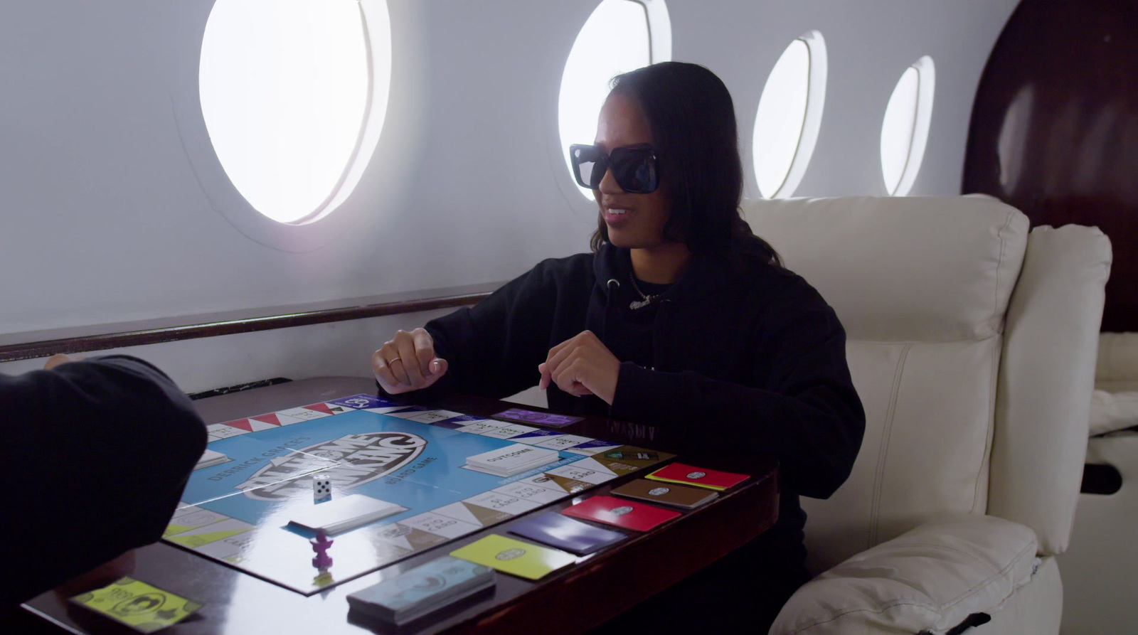 a person sitting at a table with a board game