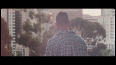 a man standing in front of a city skyline