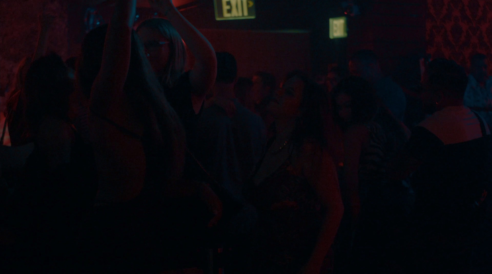 a group of people standing in a dark room