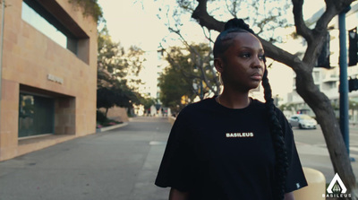 a woman standing on the side of a street