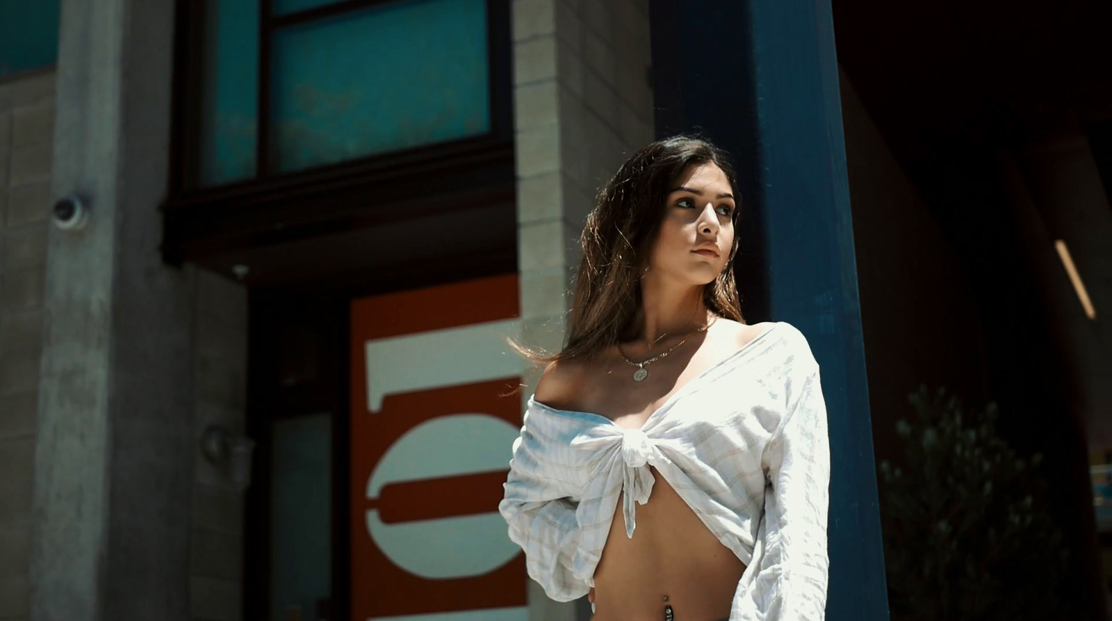 a woman in a white shirt posing for a picture