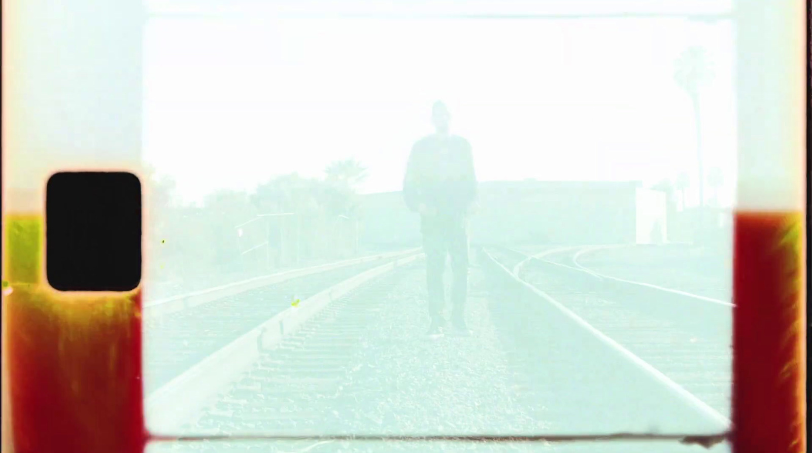 a man standing on a train track in the fog