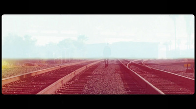 a blurry photo of a person walking on a train track