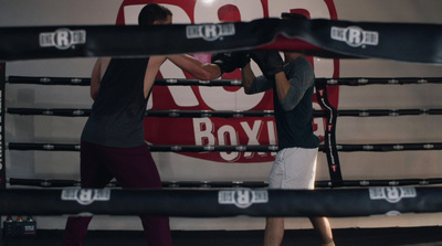 a couple of men standing next to each other in a boxing ring