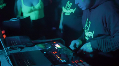 a dj mixing music in a dark room