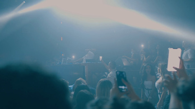 a crowd of people standing around a stage