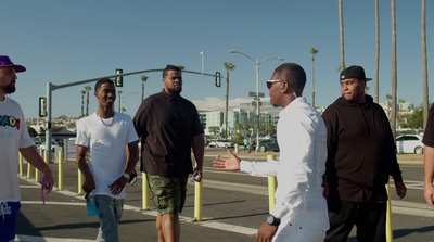 a group of men standing on the side of a road