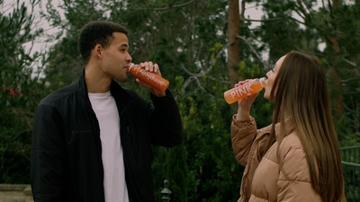 a man and a woman drinking orange juice