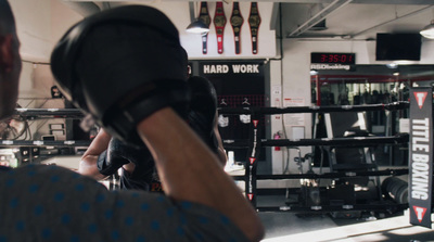 a man wearing boxing gloves in a boxing ring