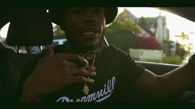 a man sitting in a car holding a cigarette