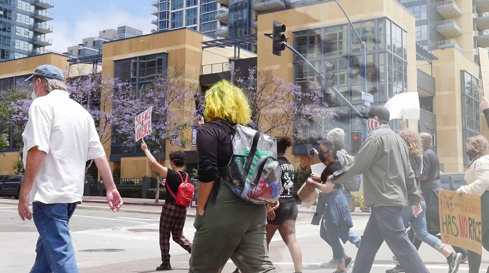 a group of people walking across a street