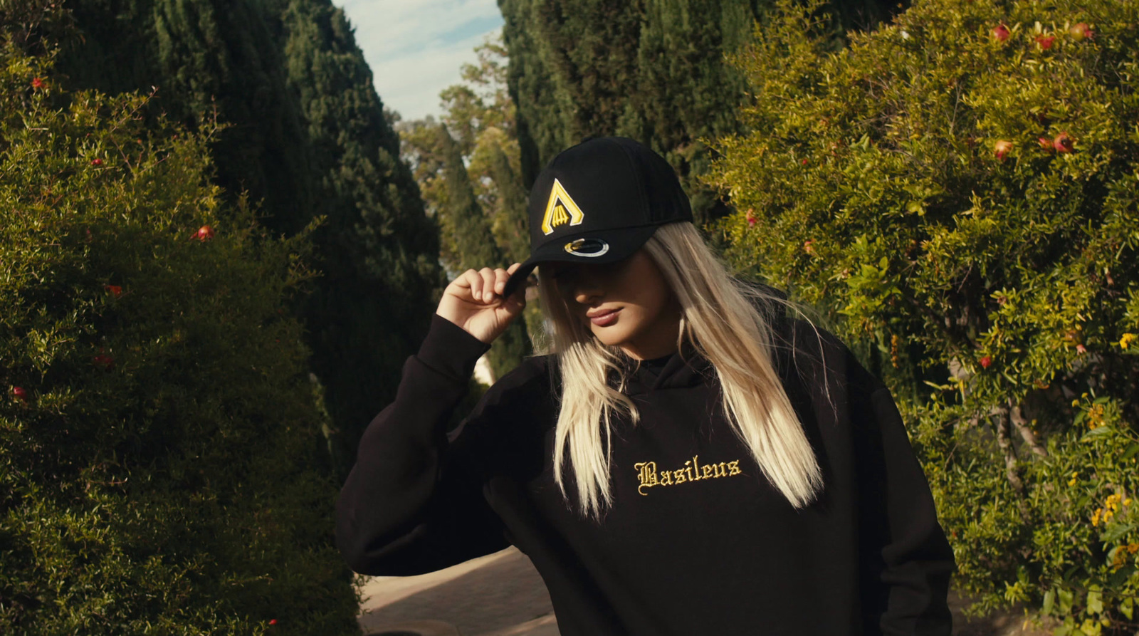 a woman wearing a black hat and a black sweatshirt