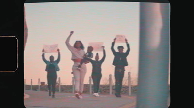 a group of people standing on top of a sidewalk