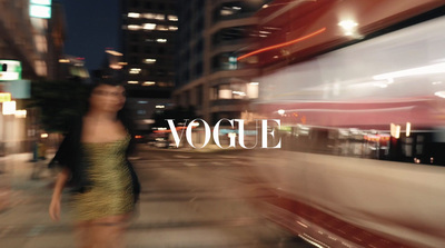 a blurry photo of a woman walking down a street