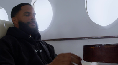 a man with a beard sitting on a plane